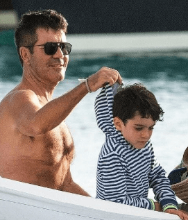 Simon is adjusting the hood of his son